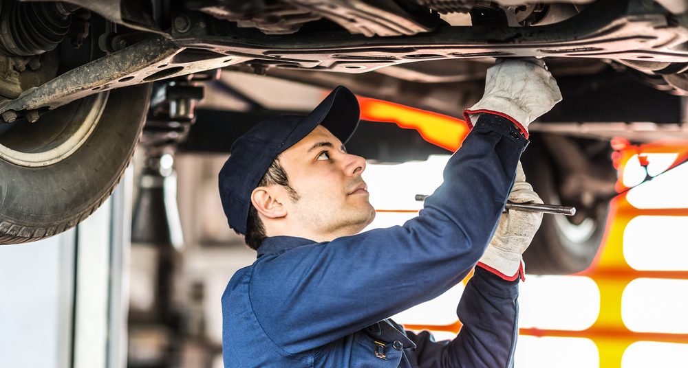 mechanic repairing a land rover