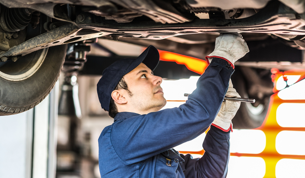 mechanic repairing a land rover